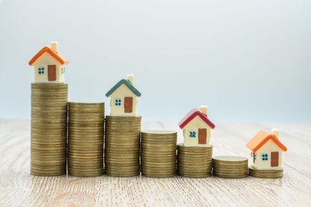 Coin pile and toy house, credit concept by house, money from coins, business, finance and money....