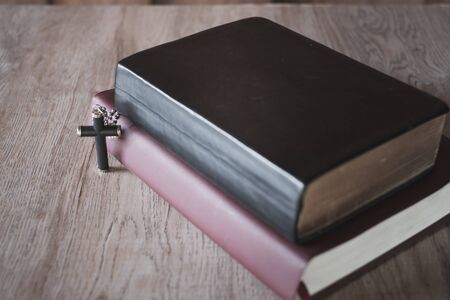 The Bible and the cross are placed near each other. The concept of asking for blessings from God. The power of holiness which brings luck and shows forgiveness with the power of religion.の写真素材