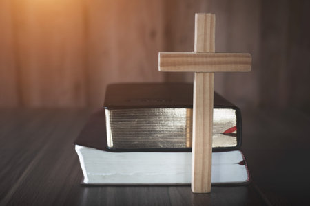 The crucifix is placed in the middle of the Bible. The idea of asking blessings from God with the power and power of holiness, which brings luck and shows forgiveness with the power of religion,faith.の写真素材