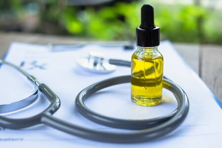 One bottle of CBD hemp oil is refined into oil. Put on prescriptions and stethoscope blurred doctor The concept of medical marijuana in the treatment of diseases has an area for entering text.の写真素材