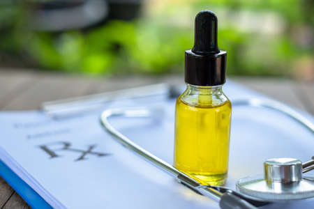 Hemp oil and medical stethoscope Placed on prescription, medical concepts, extracts used in the treatment of diseases, the pharmaceutical industry and the treatment of close-ups.の写真素材