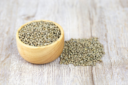 Cannabis seeds in a wooden cup Treatment ideas using cannabis oil, alternative medicine, space to place a message.の写真素材