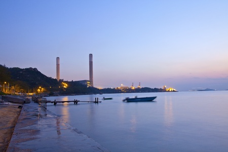 Power plant along the coast at sunset timeの写真素材