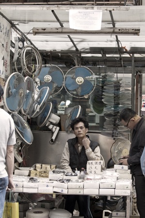HONG KONG - 17 DEC, A Chinese hawker is selling electric appliances and other accessories in Ap Liu Street, Hong Kong on 17 December, 2011. It is one of the famous street in Hong Kong.のeditorial素材