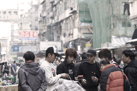 HONG KONG - 17 DEC, A Chinese hawker is selling electric appliances and other accessories in Ap Liu Street, Hong Kong on 17 December, 2011. It is one of the famous street in Hong Kong and many locals go there. のeditorial素材