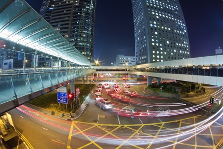 Traffic in downtown of a modern city at nightの写真素材