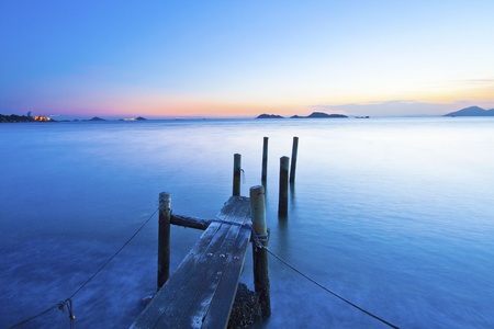 Sunset along a wooden pier の写真素材