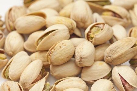 Shelled pistachio isolated on white backgroundの写真素材