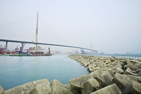 Bridge with cargo ships in Hong Kong at dayの写真素材