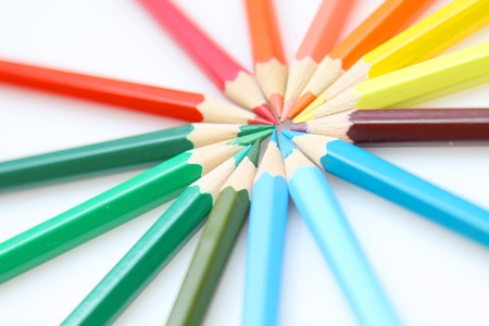 Color pencils in arrange in color wheel colors on white backgroundの写真素材