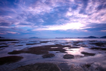 Sunset in Hong Kong along sea shore at dusk の写真素材