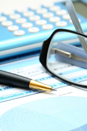 Business concept with calculator, pen and diagram.のeditorial素材