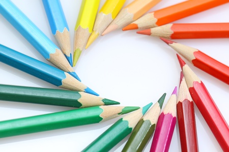 Color pencils in arrange in color wheel colors on white background の写真素材