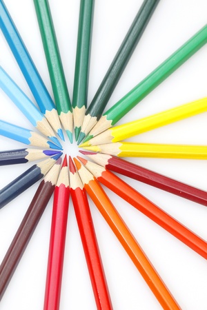 Color pencils in arrange in color wheel colors on white backgroundの写真素材