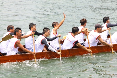 HONG KONG - JUN 6: Athletes fight hard for victory and they won at the dragon boat racing in Tuen Ng Festival 6; June 2011 in Tuen Mun; Hong Kong.のeditorial素材