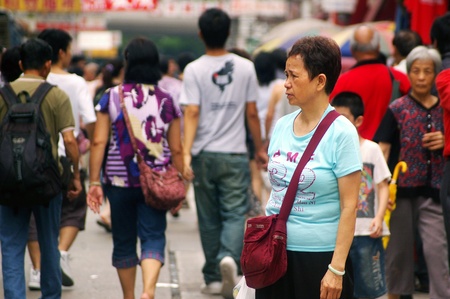 HONG KONG - JUN 21, A busy street with woman waiting in Hong Kong on 21 June, 2009. のeditorial素材