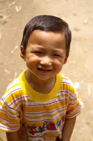 CHINA - MAY 17, A traditional Chinese young boy is smiling on Yangshuo, China on 17 May, 2010.のeditorial素材
