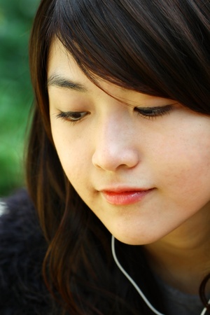 Asian woman listening musicの写真素材