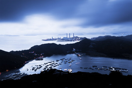 Power station at night with mountain landscape