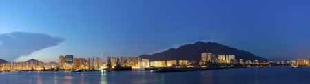 Hong Kong downtown along coast at nightの写真素材
