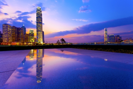 Hong Kong harbor with modern buildings at sunsetの写真素材