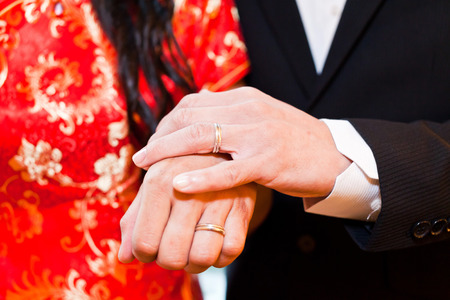 Couple holding hands in wedding dayの写真素材