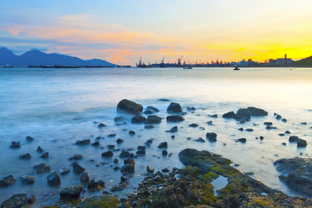 Sunset along coast with sea stonesの写真素材