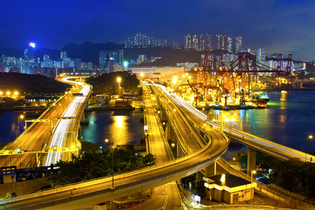 Cargo terminal traffic in city at nightの写真素材