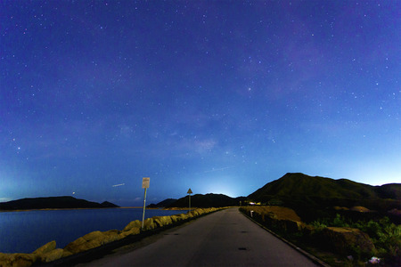 Milky Way over the reservoir at nightの写真素材