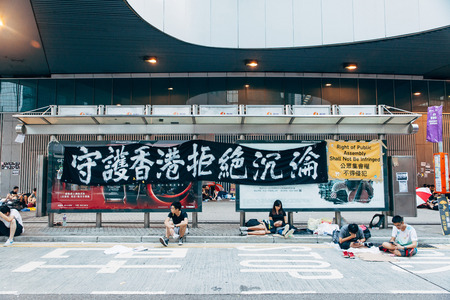 HONG KONG, OCT 2: Crowd of protesters occupy the road in Admiralty on 2 October 2014. Hong Kong people are fighting for a real universal suffrage for the next chief executive election.のeditorial素材