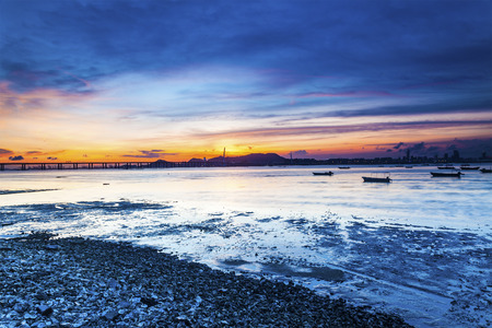 Sunset coast with a bridge connecting opposite sideの写真素材
