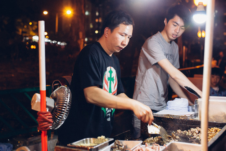 HONG KONG - FEBRUARY 20, A vendor serves a customer on a street at Tuen Mun, Hong Kong on 20 February, 2015. It is a unique street culture during the Chinese New Year holiday.のeditorial素材