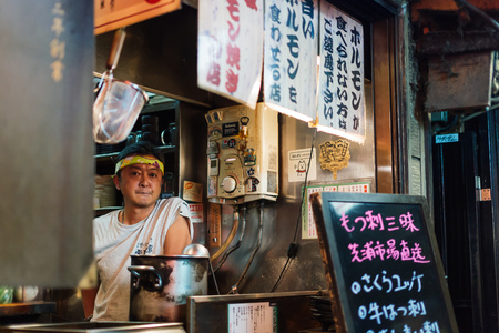 TOKYO, JAPAN - AUG 4: Shinjuku food stalls at night in Tokyo, Japan on August 4, 2015. The Japanese stalls are traditional and many local people enjoy after work at night.のeditorial素材
