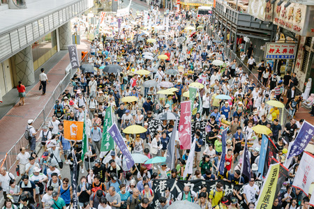 HONG KONG - JULY 1: Hong Kong people show their dissatisfaction to the Hong Kong government by march on July 1, 2015 in Hong Kong. Organizers of protest claimed a turnout of 48,000 people.のeditorial素材