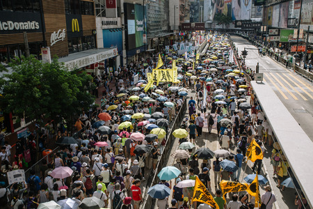 HONG KONG - JULY 1: Hong Kong people show their dissatisfaction to the Hong Kong government by march on July 1, 2015 in Hong Kong. Organizers of protest claimed a turnout of 48,000 people.のeditorial素材