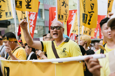 HONG KONG - JULY 1: Hong Kong people show their dissatisfaction to the Hong Kong government by march on July 1, 2015 in Hong Kong. Organizers of protest claimed a turnout of 48,000 people.のeditorial素材