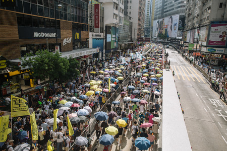 HONG KONG - JULY 1: Hong Kong people show their dissatisfaction to the Hong Kong government by march on July 1, 2015 in Hong Kong. Organizers of protest claimed a turnout of 48,000 people.のeditorial素材
