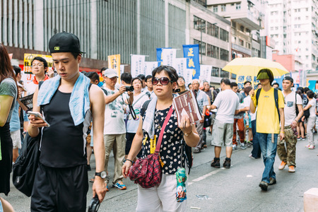 HONG KONG - JULY 1: Hong Kong people show their dissatisfaction to the Hong Kong government by march on July 1, 2015 in Hong Kong. Organizers of protest claimed a turnout of 48,000 people.のeditorial素材