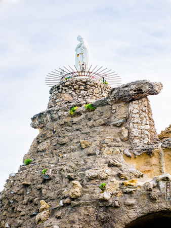 The statue of the Virgin Mary sits atop the rock formation at Rocher de la Vierge, Biarrtiz, Basque Countryの写真素材