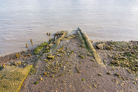 The low tide reveals the muddy riverbank and old pathways into the River Thames,の写真素材