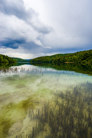 Storm clouds approach the Plitivice lakes in Croatia, a Unesco world heritage site.の写真素材