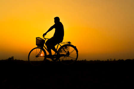 Bicycle in silhouette of the sunset.の写真素材