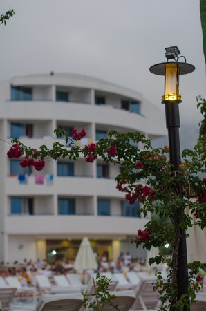 Burning lantern wrapped with flowers in front of the hotelの写真素材
