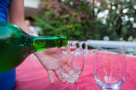 girl pours a glass of wine. rest and alcohol.の写真素材
