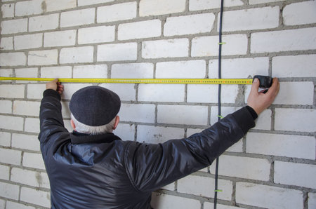 A man measures the wiring, accuracy is important.の写真素材