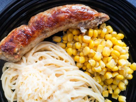 Corn and Sausage Pasta. Pasta with sausages. Creative food art idea for children meal top view