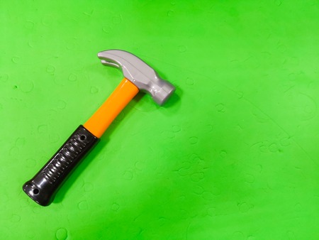 Children's hammer, on a green background. The tool for the child, etsky repairman, development for children, preparing the child for adult lifeの写真素材