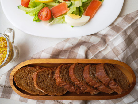Vegetable Salad with Breadon a white plate, with bread on a deep board. healthy food, green...