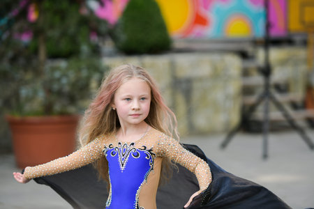 One beautiful young girl fits a modern dancer in a blue suit, a young dancer, dancing and jumping, Dance with a scarf. Young girl dancing in blueのeditorial素材