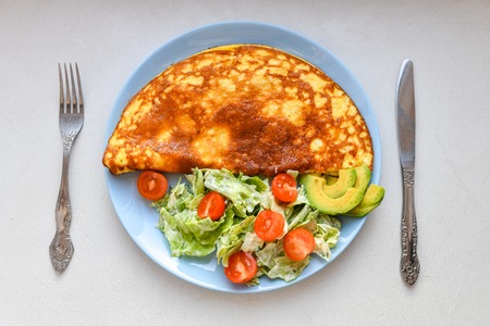 Fried eggs with vegetable salad. Omelet with vegetable salad.の写真素材